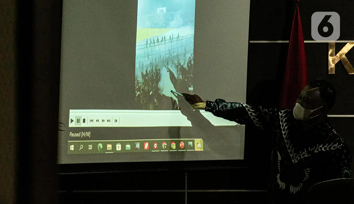 Komisioner Komnas HAM Mohammad Choirul Anam menunjukkan gambar saat menyampaikan keterangan terkait kesimpulan dari hasil penyelidikan tragedi Kanjuruhan di Gedung Komnas HAM, Jakarta, Rabu (2/11/2022). Dari penyelidikan, Komnas HAM mengatakan pengawas pertandingan atau match commisioner tidak mengetahui kalau penggunaan gas air mata dilarang dalam pengamanan pertandingan bola. (Liputan6.com/Faizal Fanani)