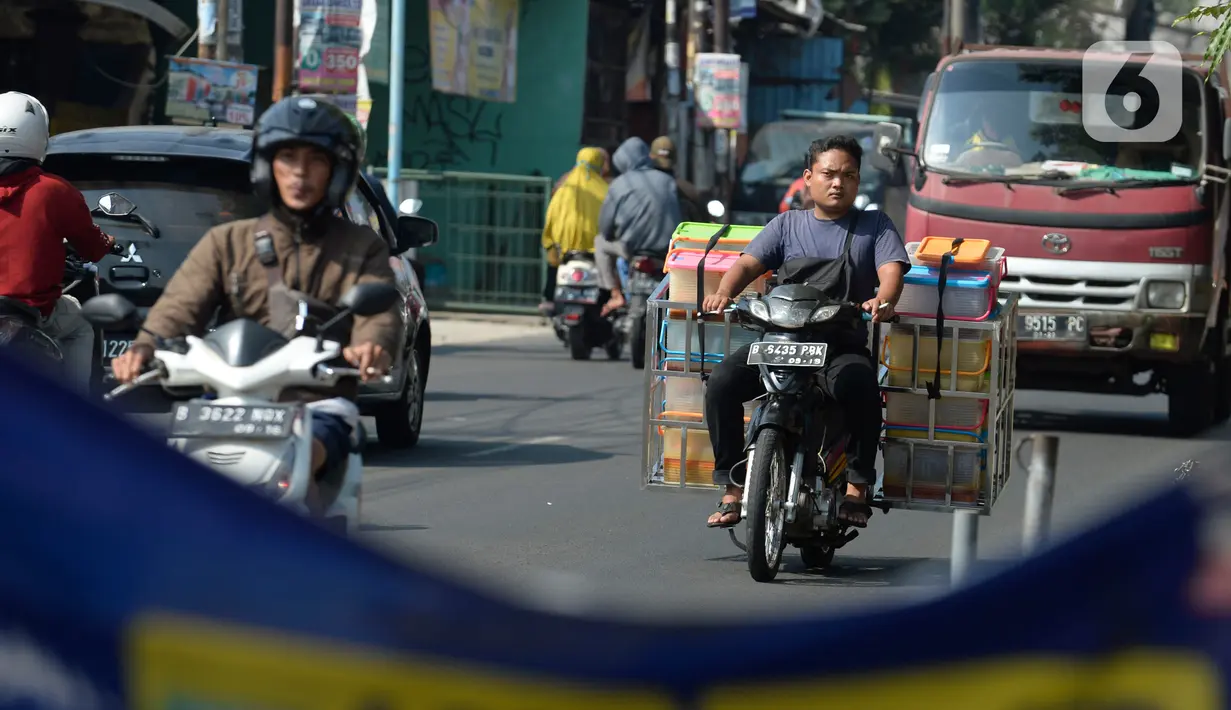Pengendara motor tidak mengenakan masker melintas di Tangerang Selatan, Banten, Rabu (22/7/2020). Warga masih tidak peduli kesehatan dirinya sendiri dan orang lain, tentang bahayanya penyeberan virus corona (COVID-19) yang terus meningkat di Indonesia. (merdeka.com/Dwi Narwoko)