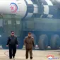 Kim Jong-un yang tampil dengan jaket kulit dan kacamata hitam, efek video dan musik dramatis (AFP)