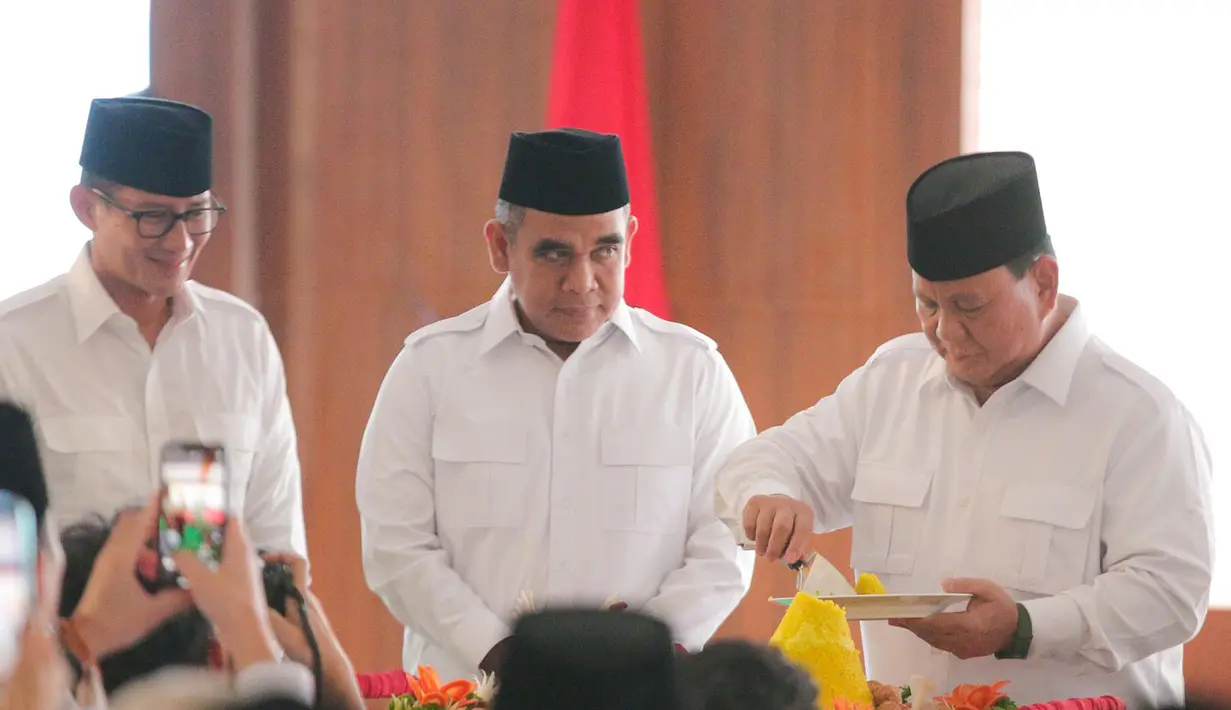Ketua Umum Partai Gerindra, Prabowo Subianto (kanan) memotong tumpeng disaksikan Wakil Ketua Dewan Pembina Partai Gerindra Sandiaga Uno (kiri) dan Sekretaris Jenderal Gerindra Ahmad Muzani (tengah) saat perayaan HUT ke-15 Partai Gerindra, di Kantor DPP Partai Gerindra, Jakarta, Senin (6/2/2023). HUT ke-15 Partai Gerindra merupakan momen berharga karena dilaksanakan sebelum Pemilu 2024 dan juga untuk melakukan konsolidasi internal untuk semakin memperkuat kekuatan partai. (Liputan6.com/Faizal Fanani)