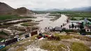 Rekaman video yang terlihat di media sosial menunjukkan arus besar air berlumpur membanjiri jalan-jalan. (Atif Aryan / AFP)