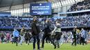 Suporter Manchester City berlari memasuki lapangan usai laga Manchester City melawan Swansea City pada lanjutan Premier League di Etihad Stadium, Manchester, (22/4/2018). Manchester City menang 5-0. (AP/Rui Vieira)