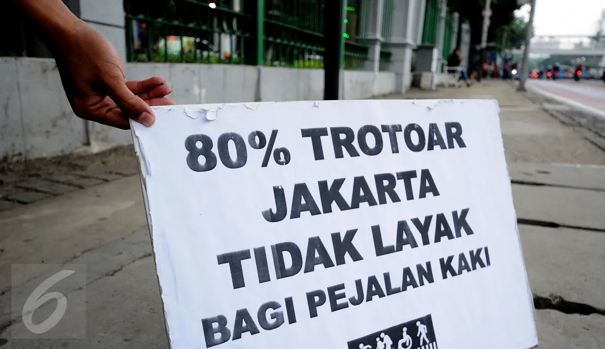 Salah satu tulisan yang dikampanyekan oleh anggota Pramuka yang tergabung dalam Askara saat melakukan aksi peduli pedestrian di sekitar Jalan Medan Merdeka Timur, Jakarta, Jumat (17/3). (Liputan6.com/Helmi Fithriansyah)