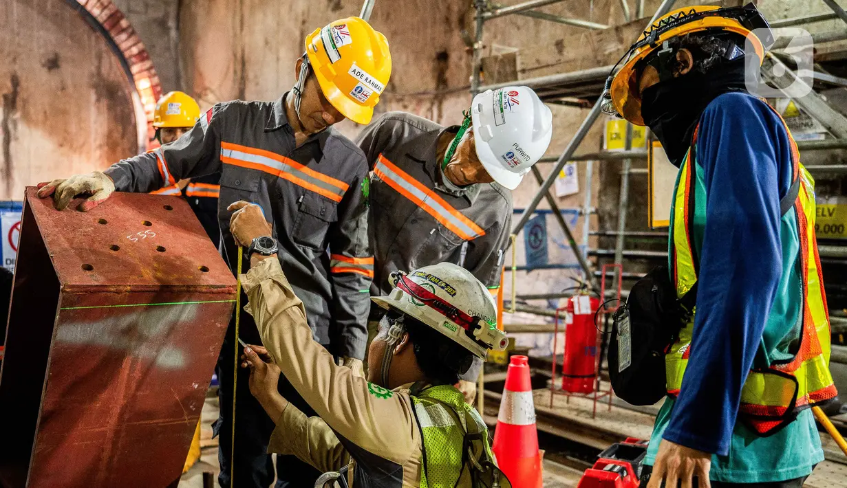 Pekerja mengecek mesin bor terowongan (tunnel boring machine) pembangunan jalur MRT Jakarta fase 2A CP 203 di terowongan bawah tanah Stasiun Kota, Jakarta, Kamis (11/7/2024). (Liputan6.com/Herman Zakharia)