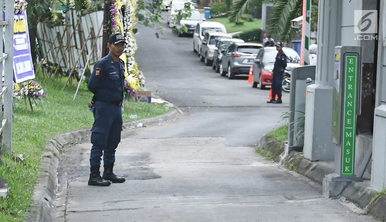 Seorang petugas keamanan berjaga di dekat rumah duka pakar kuliner Bondan Winarno di Perumahan Sentul City, Bogor, Rabu (29/11). Selain rumah duka, komplek kediaman rumah Bondan juga dijaga ketat petugas kemanan. (Liputan6.com/Herman Zakharia)