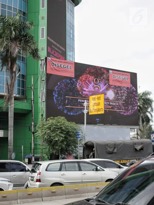 Sebuah Layar reklame tampak disegel di kawasan perempatan Harmoni, Jakarta, Selasa (29/1). Reklame yang disegel seluruhnya berlokasi di kawasan kendali ketat. (Liputan6.com/Faizal Fanani)