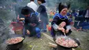 Orang-orang dari etnis minoritas Miao menyiapkan makanan setelah upacara pengorbanan untuk dewa gunung di Jianhe di provinsi Guizhou barat daya China (15/4). (AFP Photo/China Out)