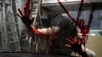 Pemeran zombie tampil dengan darah palsu yang disiramkan ke kaca kendaraan saat demonstrasi pertunjukan rumah hantu drive-in di Tokyo, Jepang, Selasa (18/8/2020). Rumah hantu drive-in ini diadakan di tengah pandemi COVID-19. (AP Photo/Eugene Hoshiko)