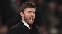 Legenda lini tengah Old Trafford itu akan memimpin The Red Devils hingga akhir musim ini. Tampak dalam foto, Michael Carrick saat masih menjadi pelatih sementara Manchester United memberi isyarat di pinggir lapangan selama pertandingan sepak bola Liga Premier Inggris melawan Arsenal di Old Trafford, Manchester, Inggris barat laut, pada 2 Desember 2021. (Oli SCARFF/AFP)