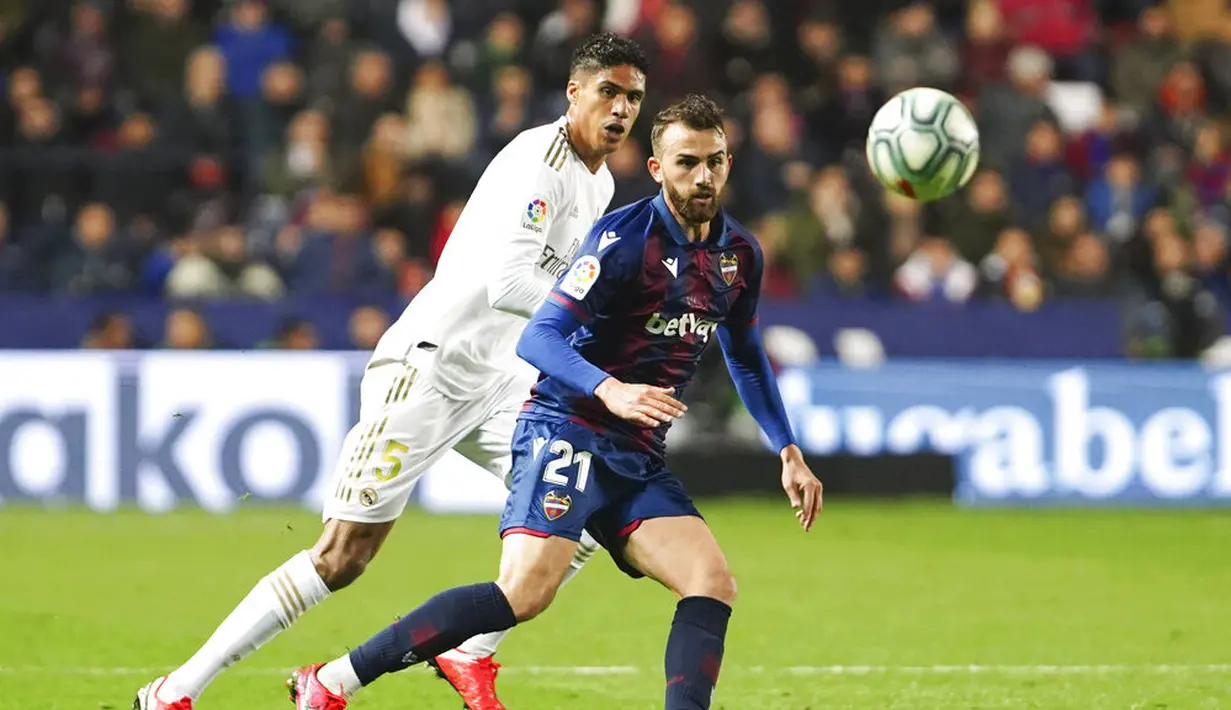 Bek Real Madrid, Raphael Varane, mengawal pemain Levante, Borja Mayoral, pada laga La Liga di Stadion Ciutat de Valencia, Sabtu (22/2/2020). Levante menang 1-0 atas Real Madrid. (AP/Alberto Saiz)