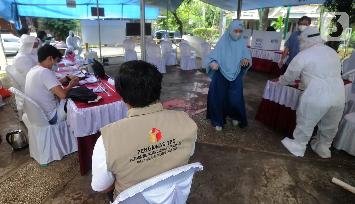 Petugas Kelompok Penyelenggara Pemungutan Suara (KPPS) memakai baju hazmat saat Pilkada Tangerang Selatan 2020 di TPS 46, Paku Jaya, Serpong Utara, Rabu (9/12/2020). Para petugas KPPS di TPS 46 ini mengunakan seragam APD untuk mengantisipasi penyebaran COVID-19. (merdeka.com/Arie Basuki)