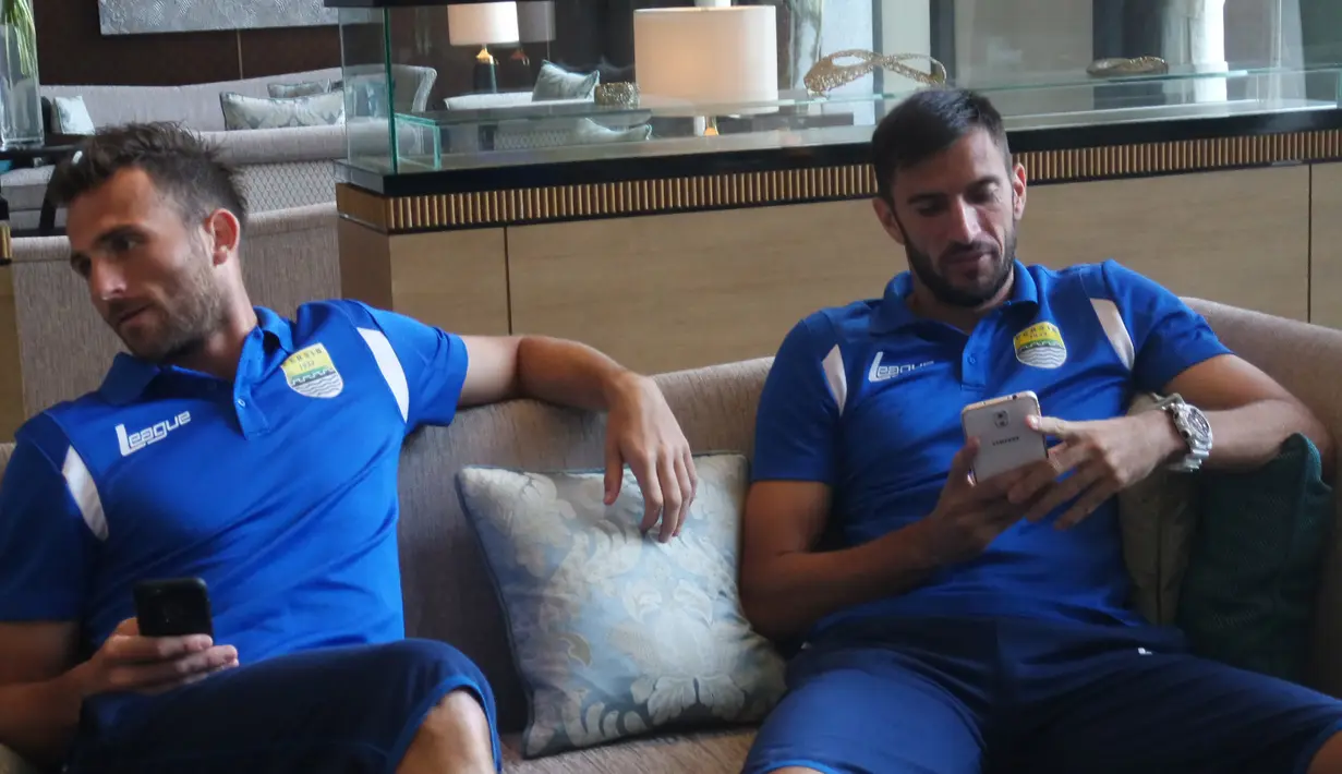 Ilija Spasojevic dan Vladimir Vujovic bermain handphone saat berada di hotel jelang laga final Piala Presiden di Stadion Utama Gelora Bung Karno. (Bola.com/Vitalis Yogi Trisna)