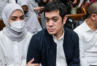 Sebelumnya, Muhammad Kerry Adrianto Riza didakwa melakukan pengaturan agar PT Jenggala Maritim Nusantara (JMN), perusahaan miliknya, memenangkan pengadaan sewa kapal dalam kerja sama dengan Pertamina. Tampak dalam foto, mantan Wakil Direktur Optimalisasi Produk di PT Kilang Pertamina Internasional, Muhammad Kerry Adrianto Riza (kanan), yang juga putra pengusaha Riza Chalid, didampingi istrinya Atya Sardadi (kiri), sesaat sebelum mengikuti sidang pembacaan vonis di Pengadilan Tindak Pidana Korupsi, Jakarta, Kamis 26 Februari 2026. (BAY ISMOYO/AFP)