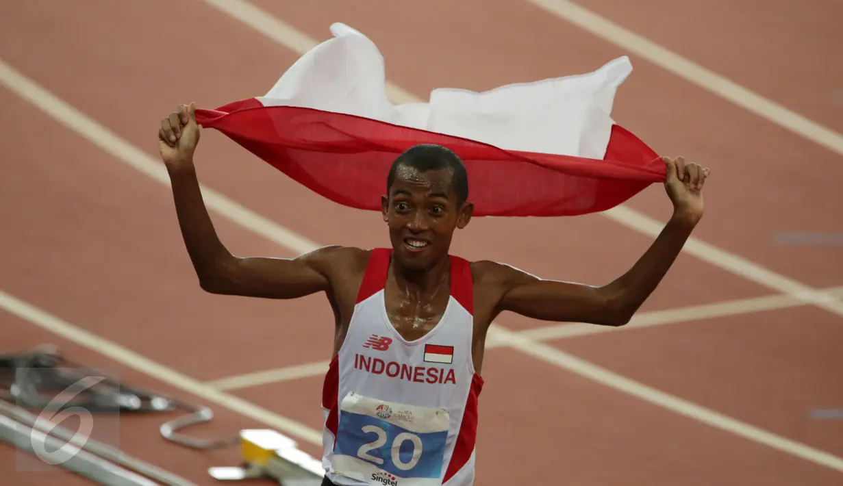Ekspresi pelari Indonesia, Agus Prayogo saat merayakan kemenangannya di nomor lari 10.000 m putra SEA Games 2015 di National Stadium, Singapura, Rabu (10/6/2015). Agus berhasil meraih emas ketiga dari cabang atletik. (Liputan6.com/Helmi Fithriansyah)
