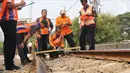 Sejumlah petugas KAI memeriksa rel kereta di dekat Stasiun Palmerah, Jakarta, Sabtu (13/10). Perjalanan KRL lintas Tanah Abang hingga Rangkasbitung dilakukan bergantian jalur hingga perbaikan selesai. (Liputan6.com/Herman Zakharia)