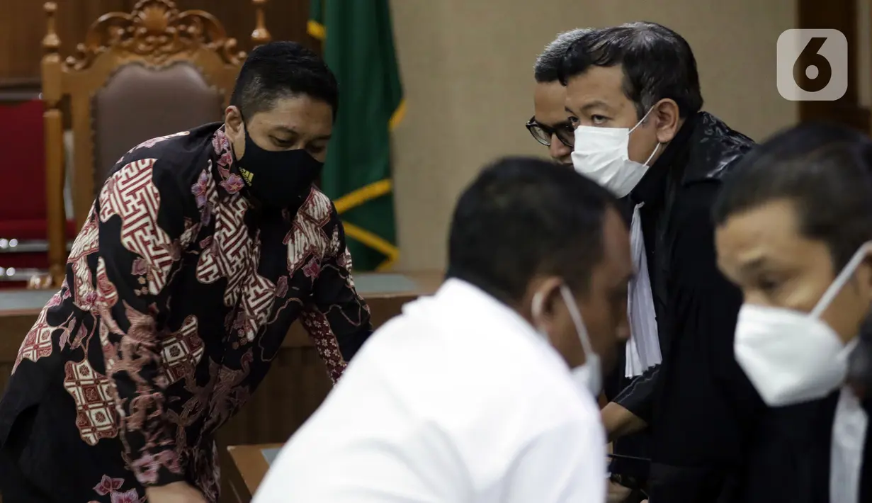 Mantan penyidik KPK, Stepanus Robin Pattuju (kiri) saat mengikuti sidang pembacaan putusan di Pengadilan Tipikor Jakarta, Rabu (12/1/2022). Stepanus Robin Pattuju divonis 11 tahun penjara dan denda Rp 500 juta terkait suap penanganan sejumlah kasus korupsi di KPK. (Liputan6.com/Helmi Fithriansyah)