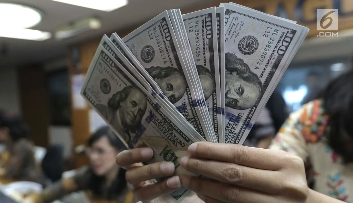 Teller menghitung mata uang dolar di penukaran uang di Jakarta, Jumat (20/4). Nilai tukar rupiah terhadap dolar AS pagi ini melemah ke posisi di Rp 13.820. (Liputan6.com/Angga Yuniar)