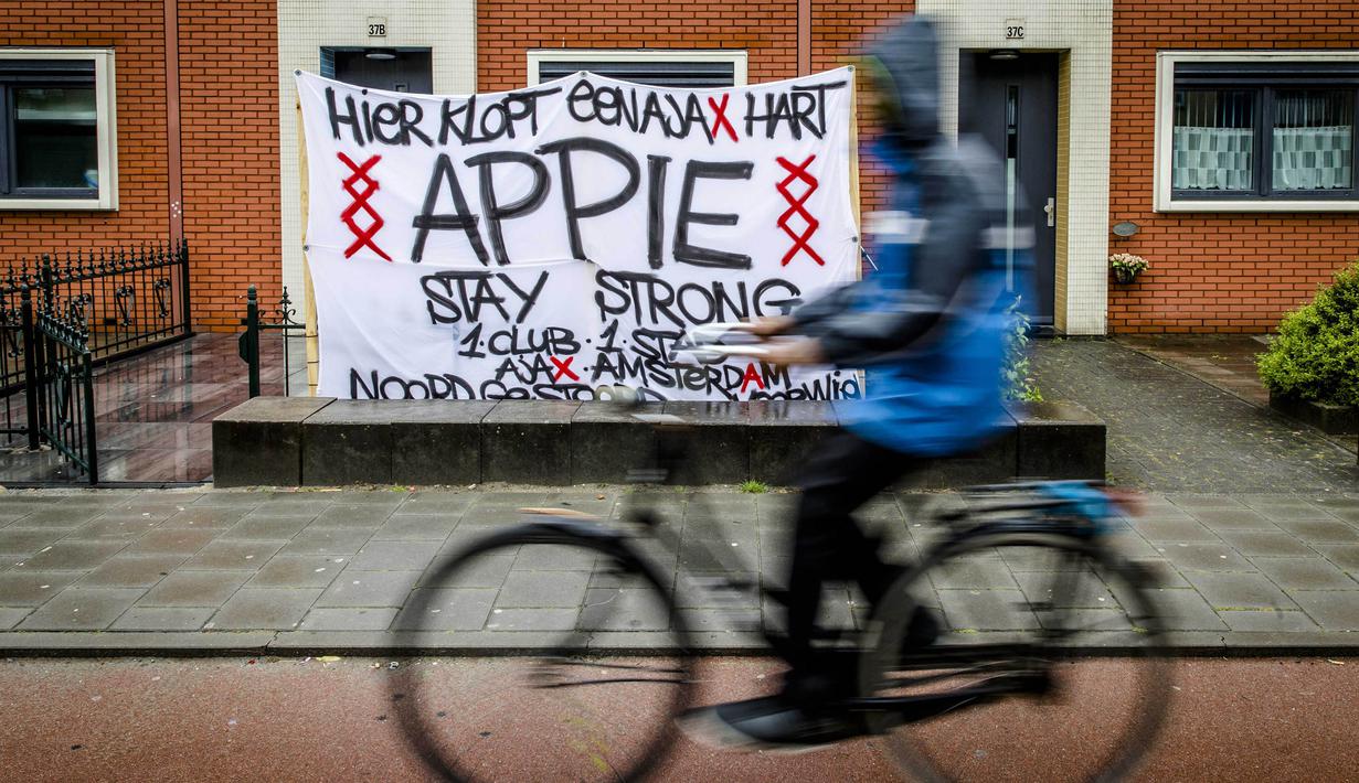 Spanduk dukungan untuk Gelandang Ajax Amsterdam, Abdelhak Nouri, terpampang di depan rumahnya, Amsterdam, Rabu (12/7/2017). Pemain berusia 20 tahun ini terancam harus mengakhiri kariernya karena mengalami kerusakan otak permanen. (AFP/Bart Maat)
