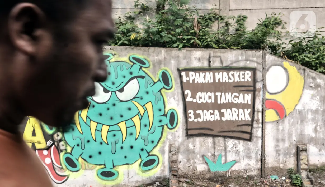 Warga melintasi mural bertema imbauan protokol kesehatan COVID-19 di kawasan Cakung Barat, Jakarta, Minggu (18/10/2020). Mural karya warga setempat tersebut bertujuan mengingatkan masyarakat akan pentingnya memakai masker, menjaga jarak, dan mencuci tangan. (merdeka.com/Iqbal S. Nugroho)