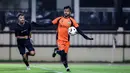 Kiper Bhayangkara FC, Aqil Savik (kanan) berusaha mengontrol bola saat laga uji coba melawan Suwon FC di Stadion PTIK, Jakarta, Senin (12/02/2024). (Bola.com/Bagaskara Lazuardi)