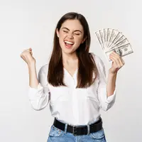 Seorang perempuan tampak bergembira sambil memegang sejumlah uang (Foto Dok: Freepik/benzoix).