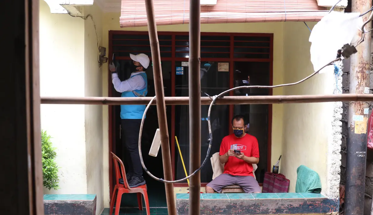 Petugas PLN melakukan pencatatan meteran listrik di rumah warga kawasan Kebayoran Baru, Jakarta, Selasa (30/6/2020). PLN memastikan seluruh petugas dikerahkan mencatat ke rumah pelanggan pascabayar untuk digunakan sebagai dasar perhitungan tagihan listrik bulan Juli 2020. (Liputan6.com/Angga Yuniar)