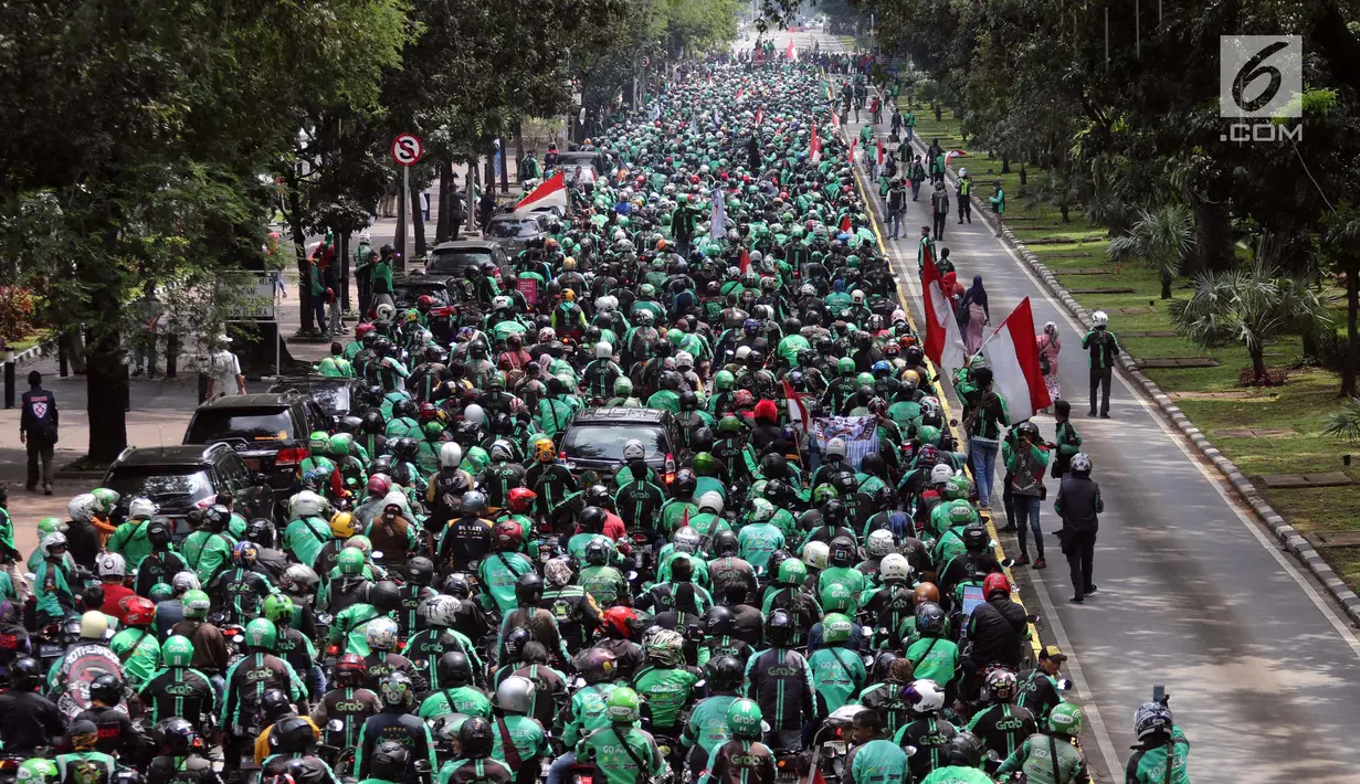Ribuan pengemudi ojek online melakukan konvoi di Jalan Medan Merdeka Barat, Jakarta, Selasa (27/3). Mereka bergerak dari IRTI Monas menuju seberang Istana Merdeka untuk menuntut Pemerintah melakukan rasionalisasi tarif. (Liputan6.com/Arya Manggala)