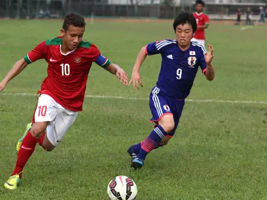 Kapten Timnas Indonesia U16, Egi Maulana, berusaha melewati pemain Jepang U16 saat ujicoba di Lapangan Padepokan Voli Indonesia di Sentul, Bogor, Jawa Barat. Selasa (15/4).