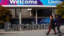 Orang-orang berjalan melewati poster yang mengumumkan Mobile World Congress (MWC) 2020 di lokasi pameran di Barcelona, Spanyol, Selasa (11/2/2020). Pembatalan MWC 2020 dilakukan setelah diadakannya pertemuan darurat oleh para petinggi penyelenggara. (AP Photo/Emilio Morenatti)