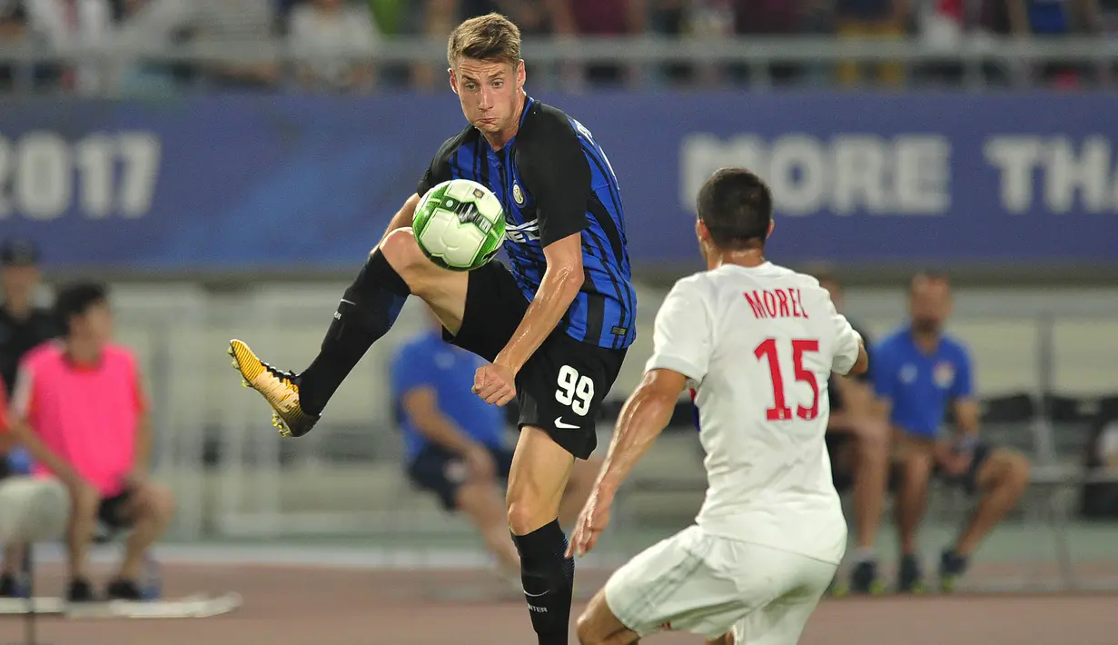 Striker Inter Milan, Andrea Pinamonti, berusaha melewati bek Lyon, Jeremy Morel, pada laga International Champions Cup di Nanjing Olympic Sports Center, Jiangsu, Senin (24/7/2017). Inter Milan menang 1-0 atas Lyon. (AFP)