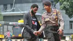 Mahasiswa Papua berjabat tangan dengan seorang polisi saat mendatangi Polda Metro Jaya, Jakarta, Selasa (1/12/2015). Kedatangan mereka untuk menunggu teman mereka yang diperiksa polisi (Liputan6.com/Yoppy Renato)