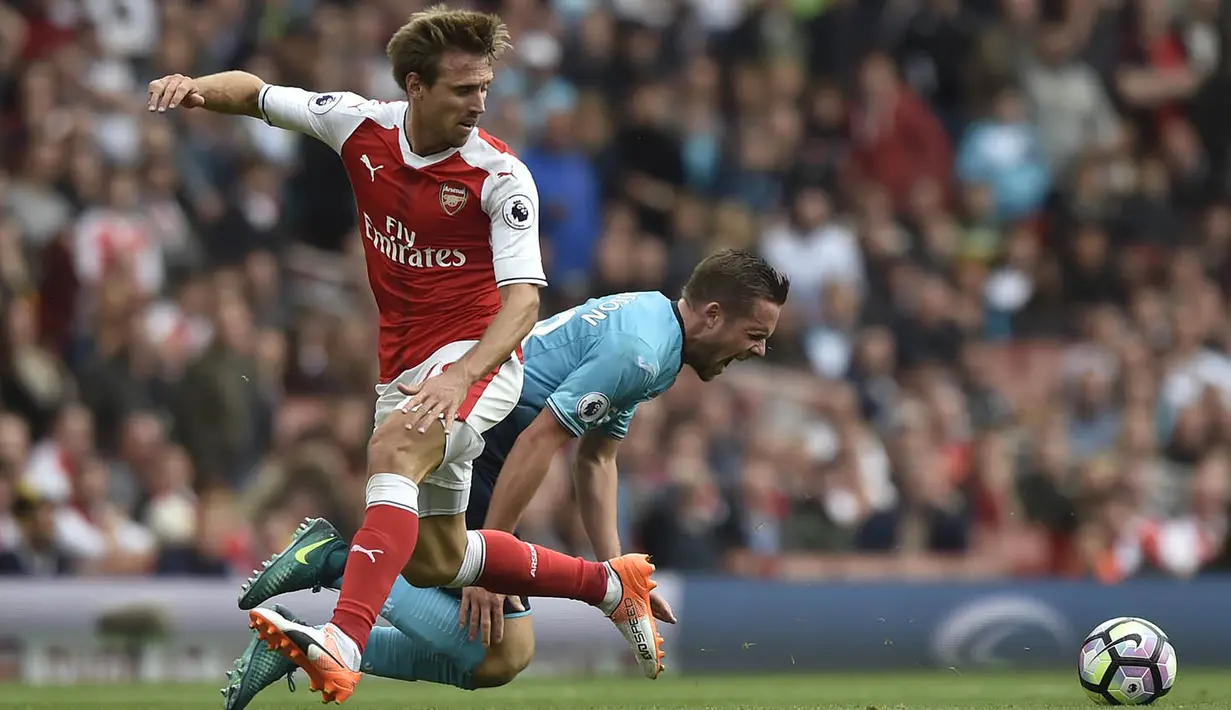 Bek Arsenal, Nacho Monreal, berebut bola dengan gelandang Swansea, Gylfi Sigurdsson, pada laga Premier League di Stadion Emirates, London, Sabtu (15/10/2016). Arsenal menang 3-2 atas Swansea. (Reuters/Hannah McKay)