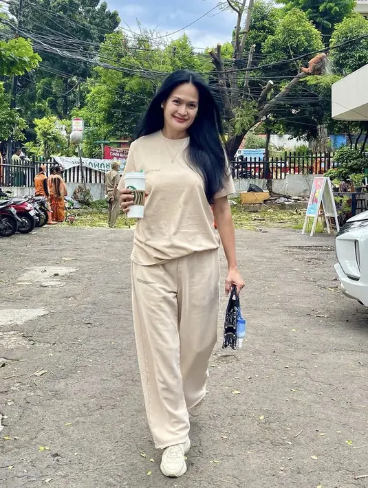 Memiliki empat cucu bukan menjadi penghalang Donna untuk tampil fashionable. Misalnya saja ia mengenakan one set warna nude dari atasan dan celana loose dipadukan sneakers dan slingbag. (@donnaharunofficial)