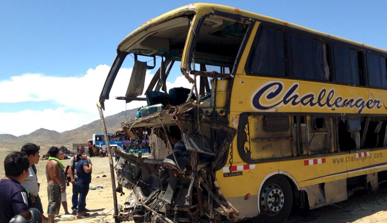 Sejumlah orang melihat kondisi bus yang mengalami tabrakan di jalan tol Kota Huarmey, Peru, Senin (23/3/2015). Insiden ini setidaknya menewaskan  34 orang tewas dan 70 luka-luka lainnya. (REUTERS/Andina Agency)
