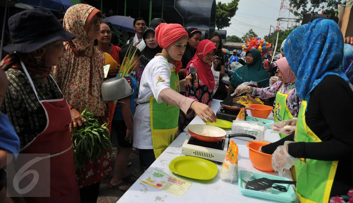 Sejumlah ibu-ibu melihat juru masak membuat jajanan tradisional di Pasar Pondok Labu, Jakarta Selatan (10/09). Acara yang diusung Gulaku untuk melestarikan jajanan tradisional Indonesia. (Liputan6.com/Gempur M Surya). 