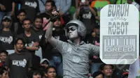 Seorang buruh mengecat tubuhnya sebagai sindiran saat perayaan hari buruh sedunia (May Day), SGBK, Jakarta, Jumat (1/5/2015). Mereka menuntut melawan kebijakan upah murah dan kenaikan upah setiap lima tahun sekali. (Liputan6.com/Herman Zakharia)