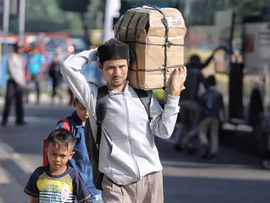 Penumpang berjalan usai turun dari bus Antar Kota Antar Provinsi di Terminal Kampung Rambutan, Jakarta, Selasa (19/6). Empat hari setelah Lebaran, jumlah penumpang yang tiba di Terminal Kampung Rambutan mencapai 17.492 orang. (Liputan6.com/Faizal Fanani)
