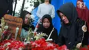 Kesedihan Ibu Julia Perez, Sri Wulansih saat sedang mendoakan di makam Julia Perez di TPU Pondok Ranggon, Jakarta, Selasa (13/6). Sang ibu, Sri Wulansih pun terlihat masih terpukul dengan kepergian Jupe. (Liputan6.com/Herman Zakharia)