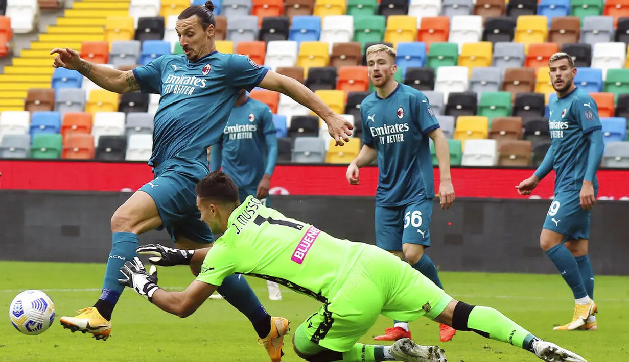 Striker AC Milan, Zlatan Ibrahimovic, berusaha melewati kiper Udinese, Juan Musso, pada laga Liga Italia di Stadion Friuli, Minggu (1/11/2020). AC Milan menang dengan skor 2-1. (Andrea Bressanutti/LaPresse via AP)