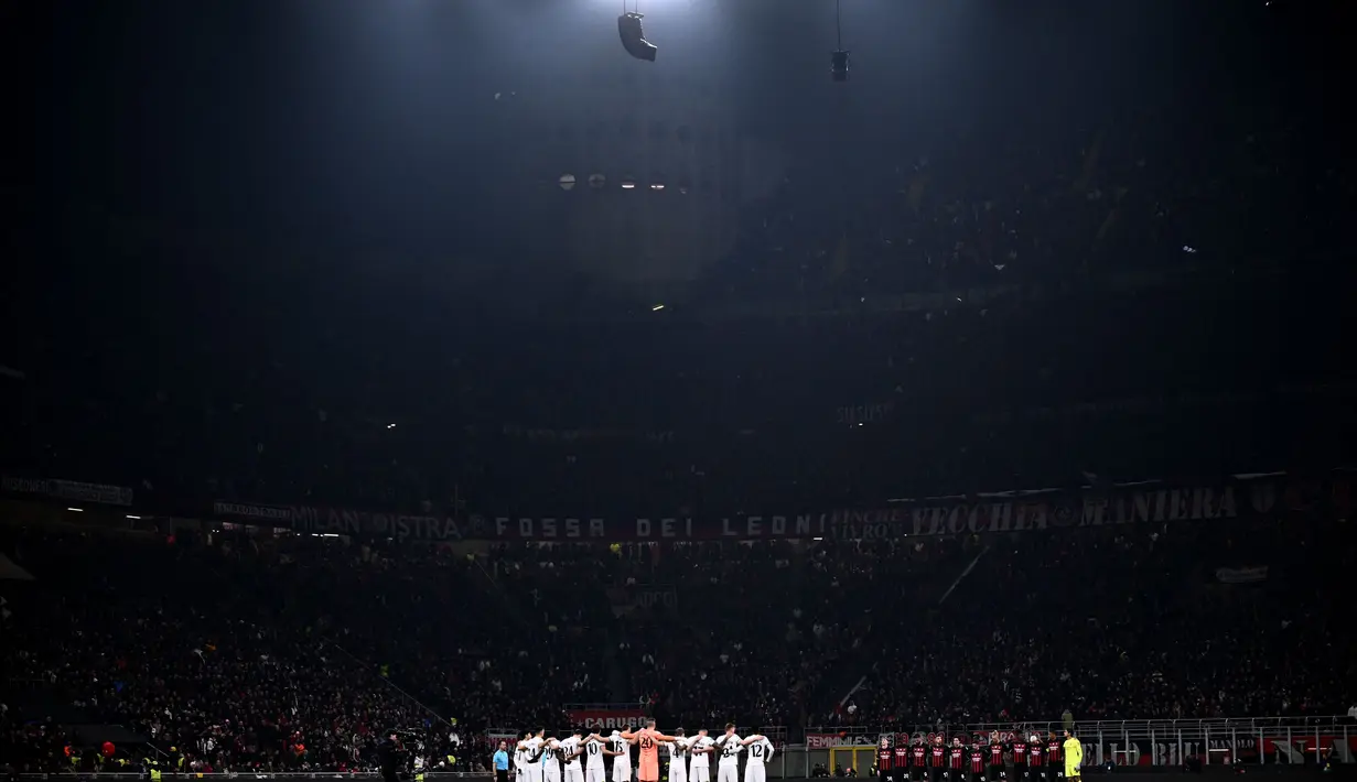 Pemain Tottenham (Kiri) dan pemain AC Milan (Kanan) bersatu untuk mengheningkan cipta untuk memperingati para korban gempa bumi yang melanda Turki dan Suriah, sebelum pertandingan babak 16 besar Liga Champions di stadion San Siro di Milan pada 15 Februari 2023. (AFP/Marco Bertorello)