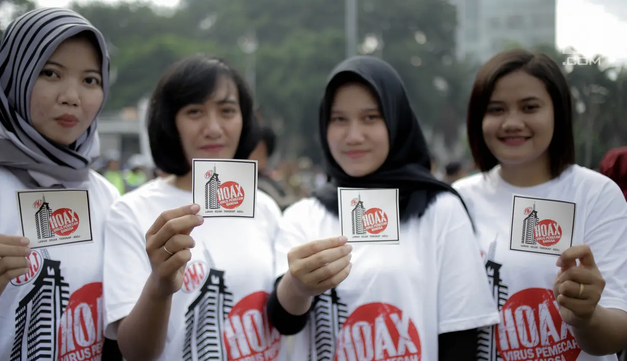 Peserta memperlihatkan stiker pesan antihoax pada  kampanye sekaligus deklarasi saat car free day di Bundaran Hotel Indonesia, Jakarta, Minggu (18/3). Kegiatan digelar Polda Metro Jaya bersama Indonesia Comunitas Club. (Liputan6.com/Faizal Fanani)