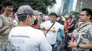 Penyandang disabilitas tuna rungu dan tuna wicara berkumpul memperingati Hari Tuli Internasional di arena Car Free Day, Jakarta, Minggu (25/9). Dalam kampanye ini, mereka memperagakan bahasa isyarat kepada warga masyarakat. (Liputan6.com/Faizal Fanani)