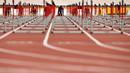 Pelari Haiti, Jeffrey Julmis of Haiti (tengah) siap berlomba di nomor lari gawang 110m putra Pan American Games 2015 di Stadion Atletik CIBC, Toronto, Kanada (24/7/2015). (AFP PHOTO/Timothy A. Clary)