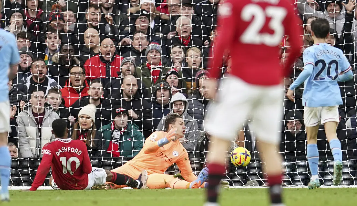 Pemain MU, Marcus Rashford (kiri) berhasil menjebol gawang Manchester City yang dijaga oleh Ederson dalam pertandingan lanjutan Liga Inggris 2022/2023. Gol ini membuat kedudukan menjadi 2-1 bagi kemenangan MU. (AP Photo/Dave Thompson)