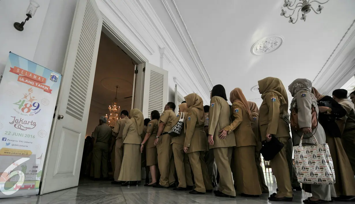 Sejumlah pegawai negeri sipil (PNS) antre masuk ke dalam Balai Kota untuk bersalaman dengan Gubernur DKI Jakarta, Senin (11/7). Gubernur Ahok menggelar halal bihalal di hari pertama kerja. (Liputan6.com/Yoppy Renato)