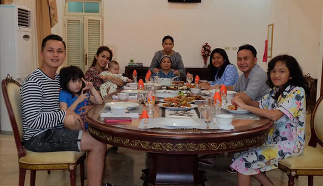 Tidak hanya foto bersama di alam terbuka, Ussy juga membagikan di depan meja makan. Ussy dan Andhika duduk berjejer tersnyum begitu juga Sugianto yang duduk didepannya."familia 🙏 silaturahmi," tulis Ussy pada Minggu 23 Juli. (Instagram/ussypratama)