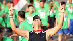 Ekpresi seorang peserta usai memasuki garis finish dalam lomba lari Jakarta International 10K 2015 di Silang Monas, Jakarta, Minggu (31/5/2015). (Liputan6.com/Helmi Afandi)
