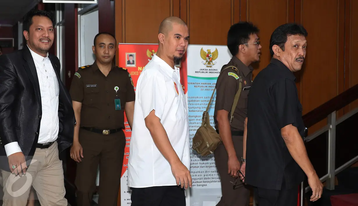 Musisi Ahmad Dhani (tengah) dan kuasa hukumnya, Ramdan Alamsyah (kiri) saat mendatangi Kejati DKI Jakarta, Jakarta, Senin (5/10/2015). Ahmad Dhani mengirimkan surat permohonan penahanan badan rutan terhadap Farhat Abbas. (Liputan6.com/Herman Zakharia) 