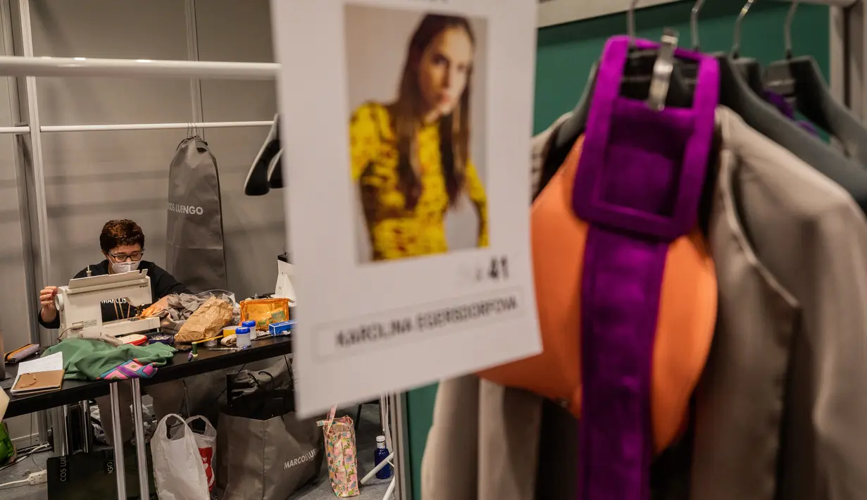Staf desainer Spanyol, Marcos Luengo bekerja di belakang panggung sehari sebelum dimulainya Mercedes-Benz Fashion Week di Madrid, Rabu (9/9/2020). Mode Spanyol berlangsung dari 10 - 13 September di bawah protokol kesehatan dan pedoman jarak sosial karena pandemi corona. (AP Photo/Bernat Armangue)