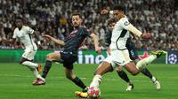 Aksi berbalas gol mewarnai laga leg pertama perempat final Liga Champions antara Real Madrid melawan Manchester City. (Pierre-Philippe MARCOU/AFP)